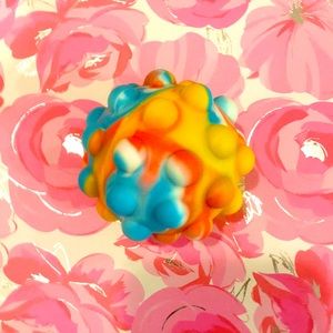 Multi colored pop it ball fidget anxiety relief, finger tip toy.